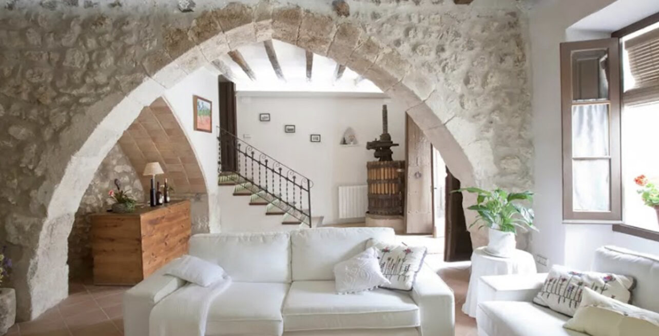Second lounge with white sofas, twin stone arches and the old wine press