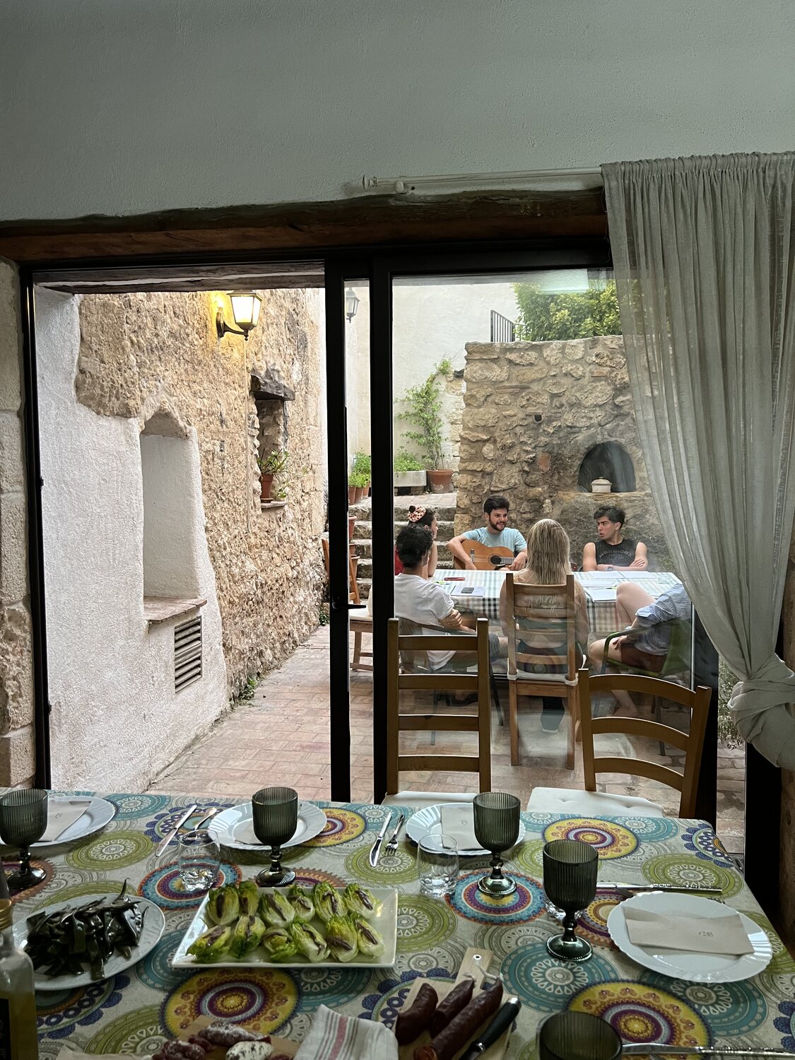 The table laid with hand-painted Catalan ceramics before dinner