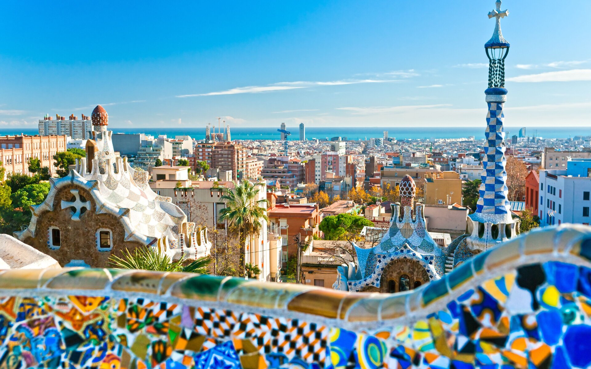 Park Güell and the Barcelona skyline down to the sea in bright midday sun