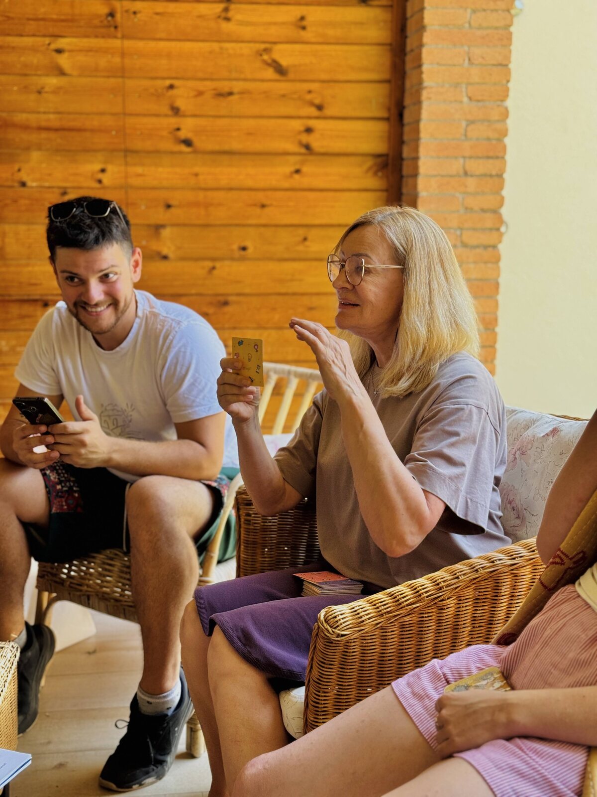 Two guests laughing together on the sofa