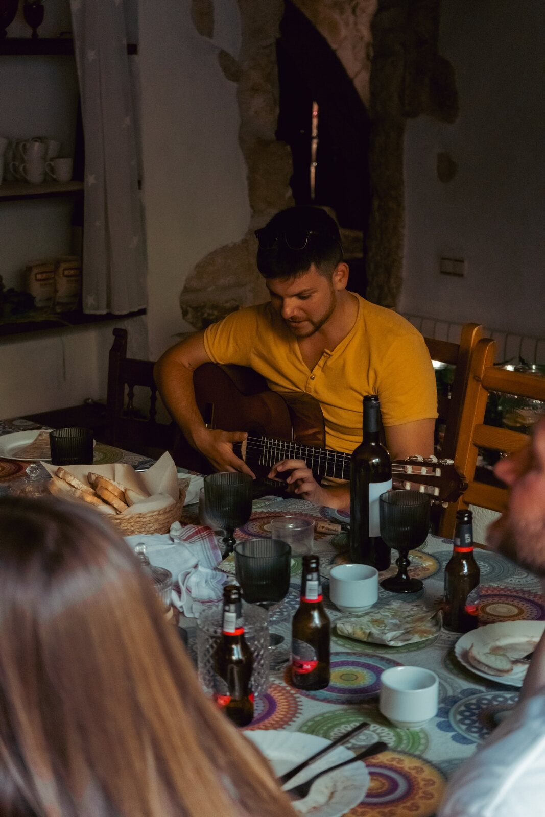 The guitar resting against the table in the evening