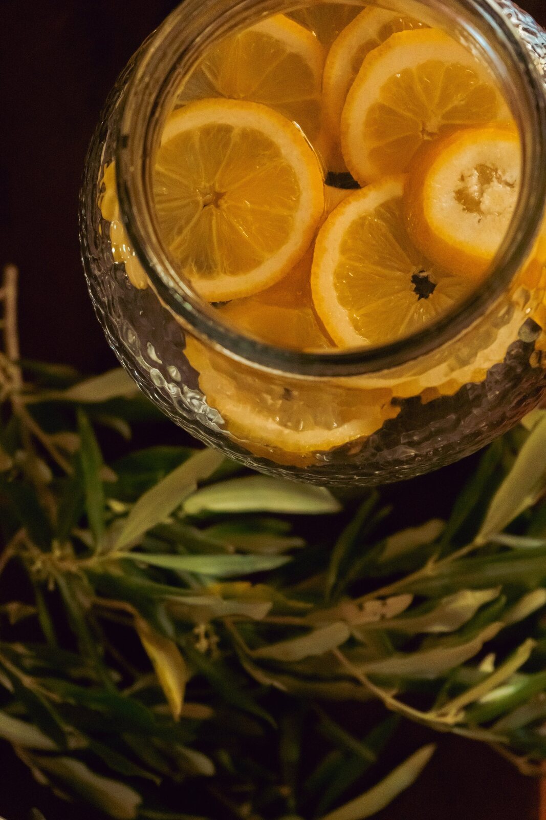 A jug of lemon water on the table in the sun