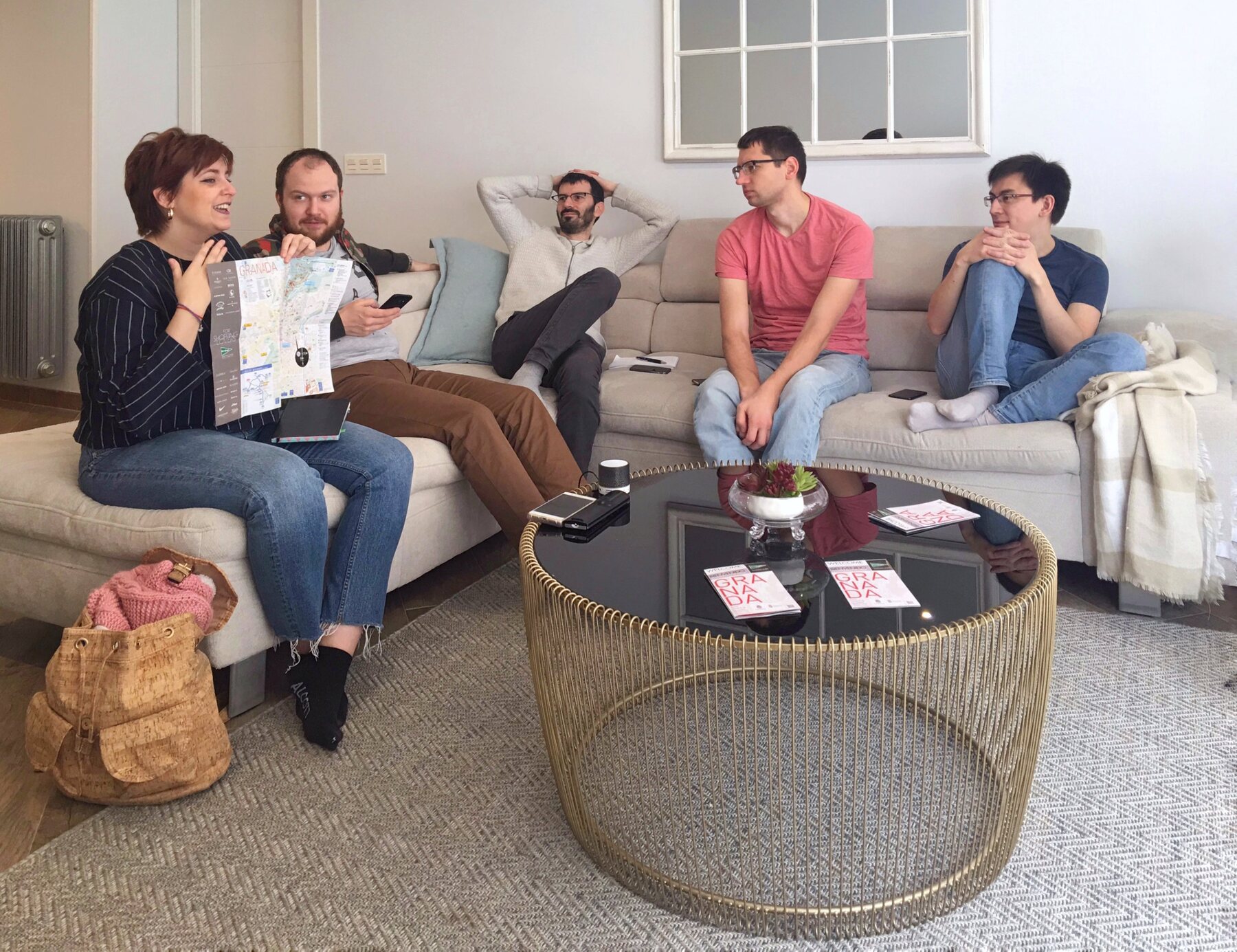 The group spread across the sofas in the living room, talking