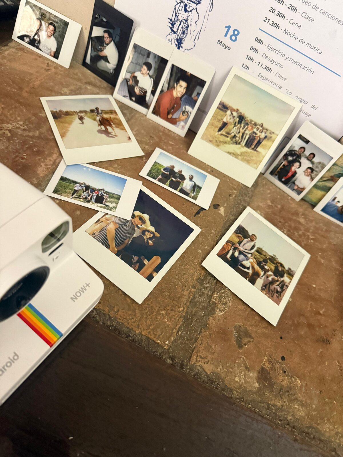 Polaroids from the weekend spread across the table