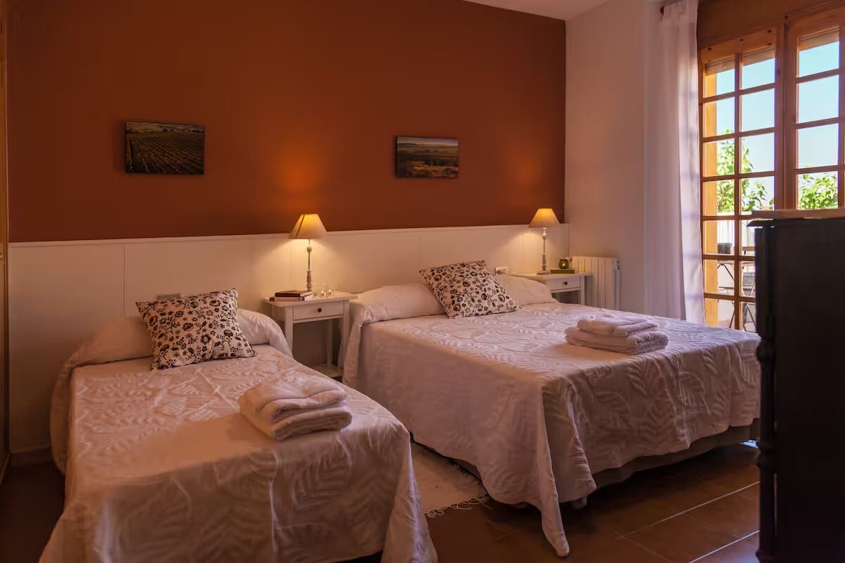 A twin room with two single beds under the sloping beamed ceiling
