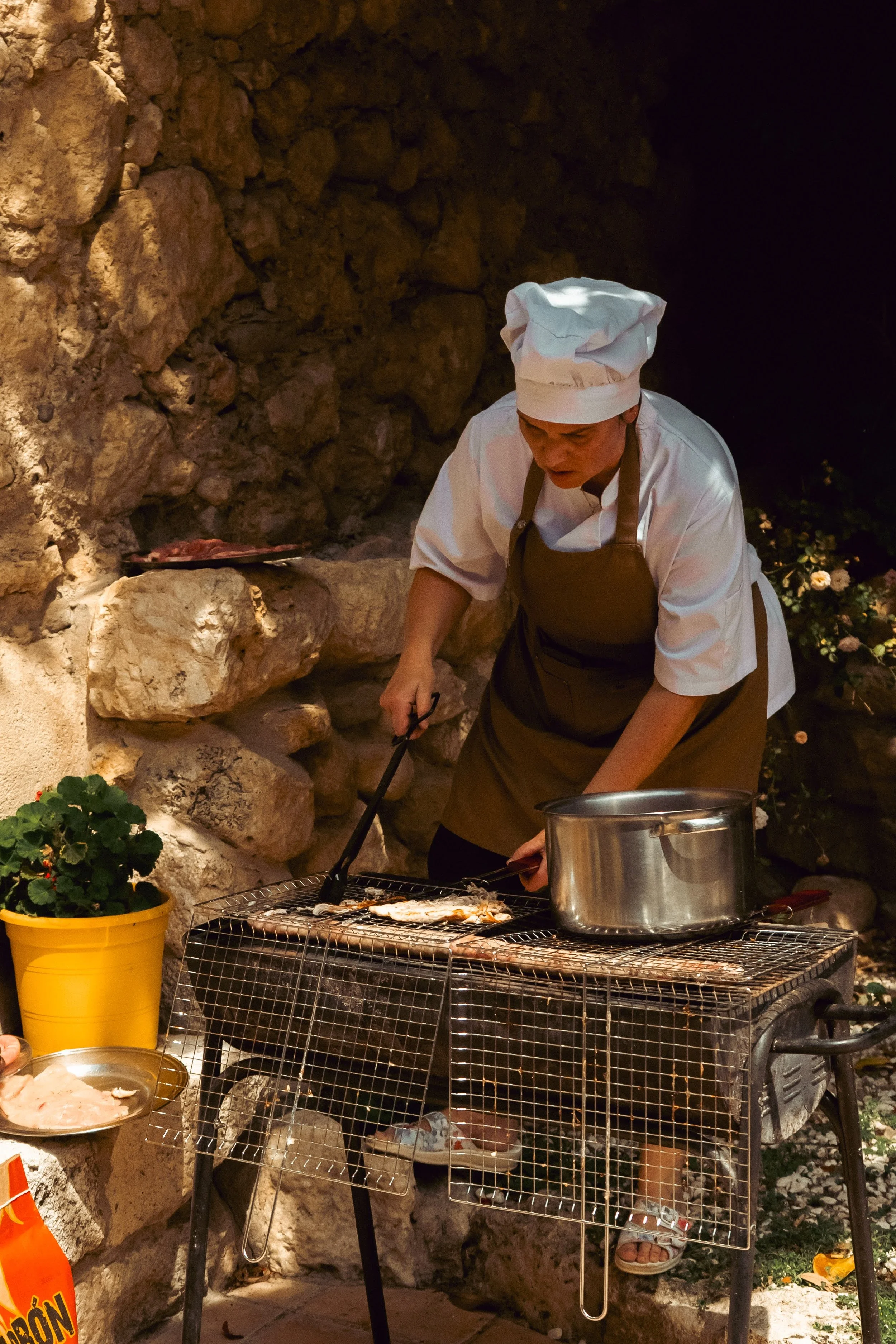 Paella cooking over the fire in the courtyard