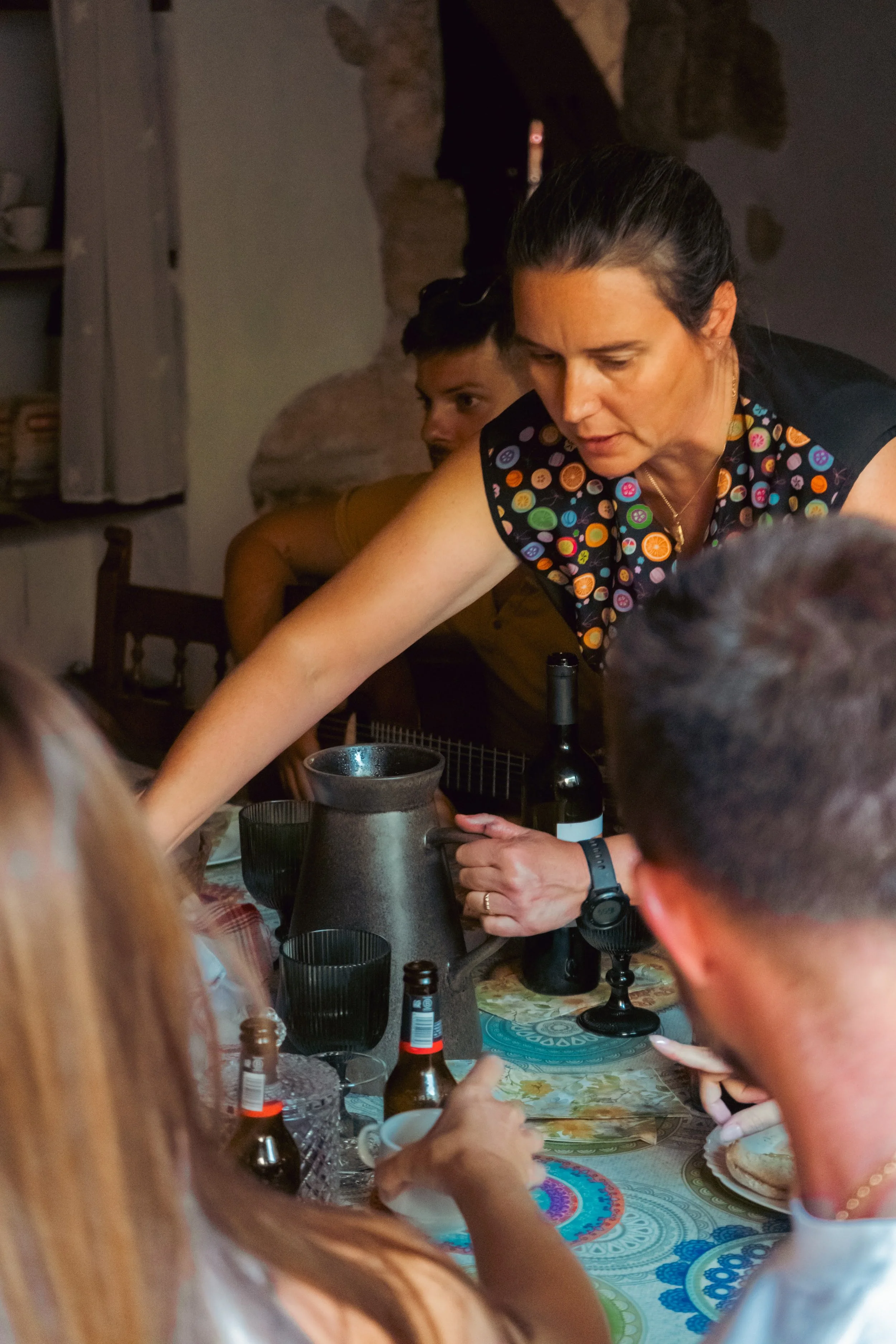 Wine being poured around the long dinner table