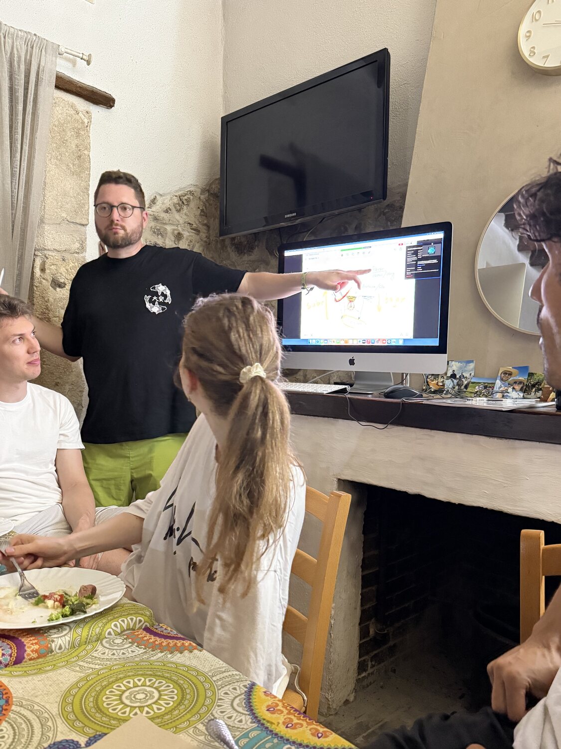 A Spanish session in progress by the fireplace, notes and laptops on the table